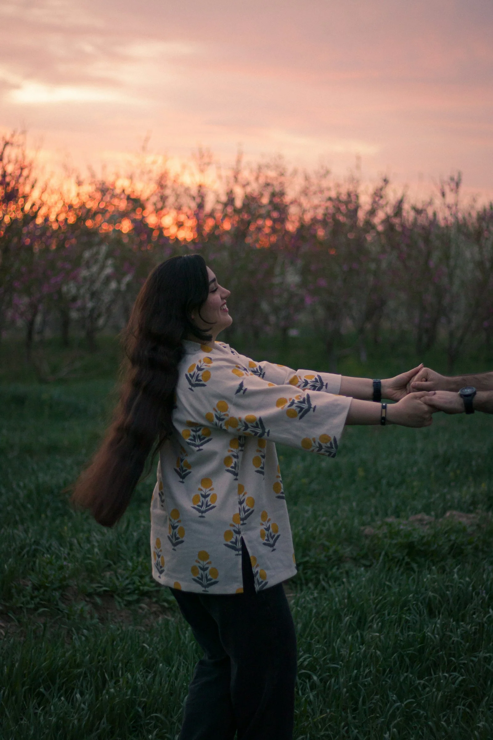 a woman holding a frisbee in a grassy field