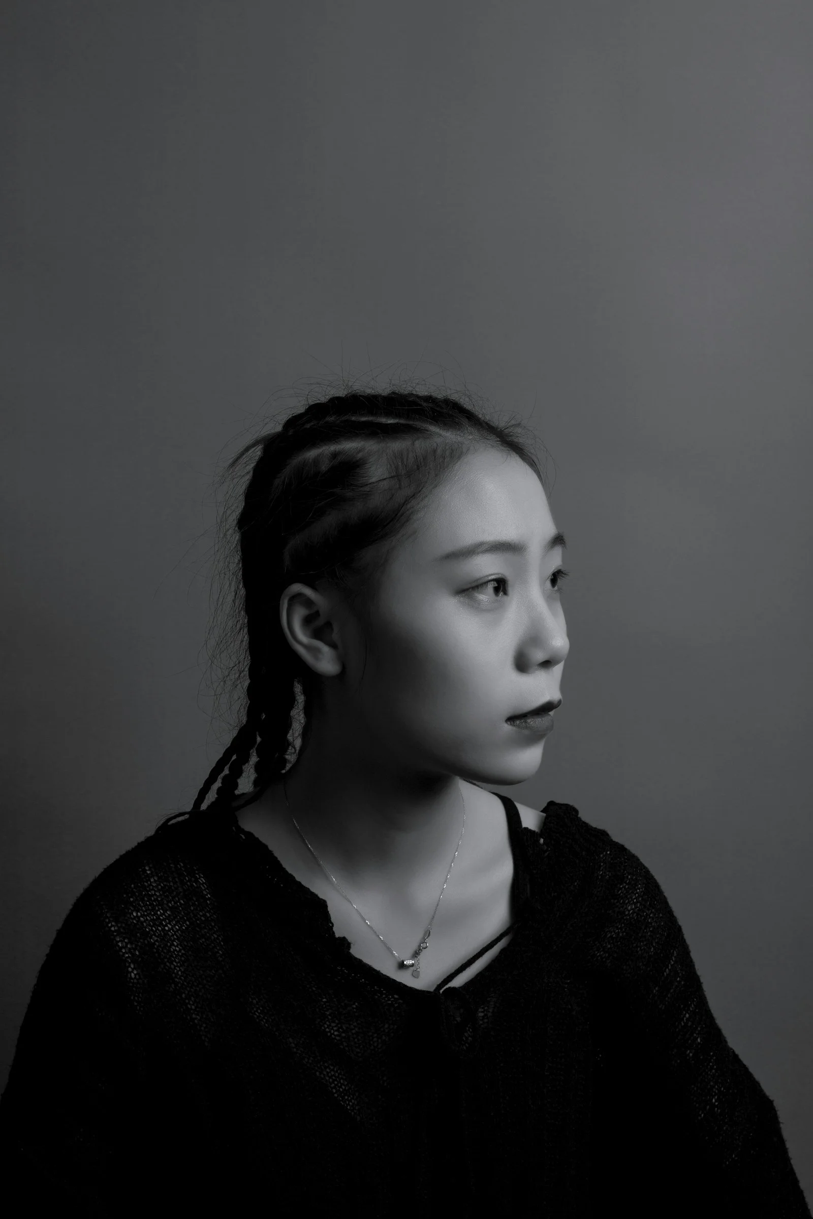greyscale photography of woman facing at right sied