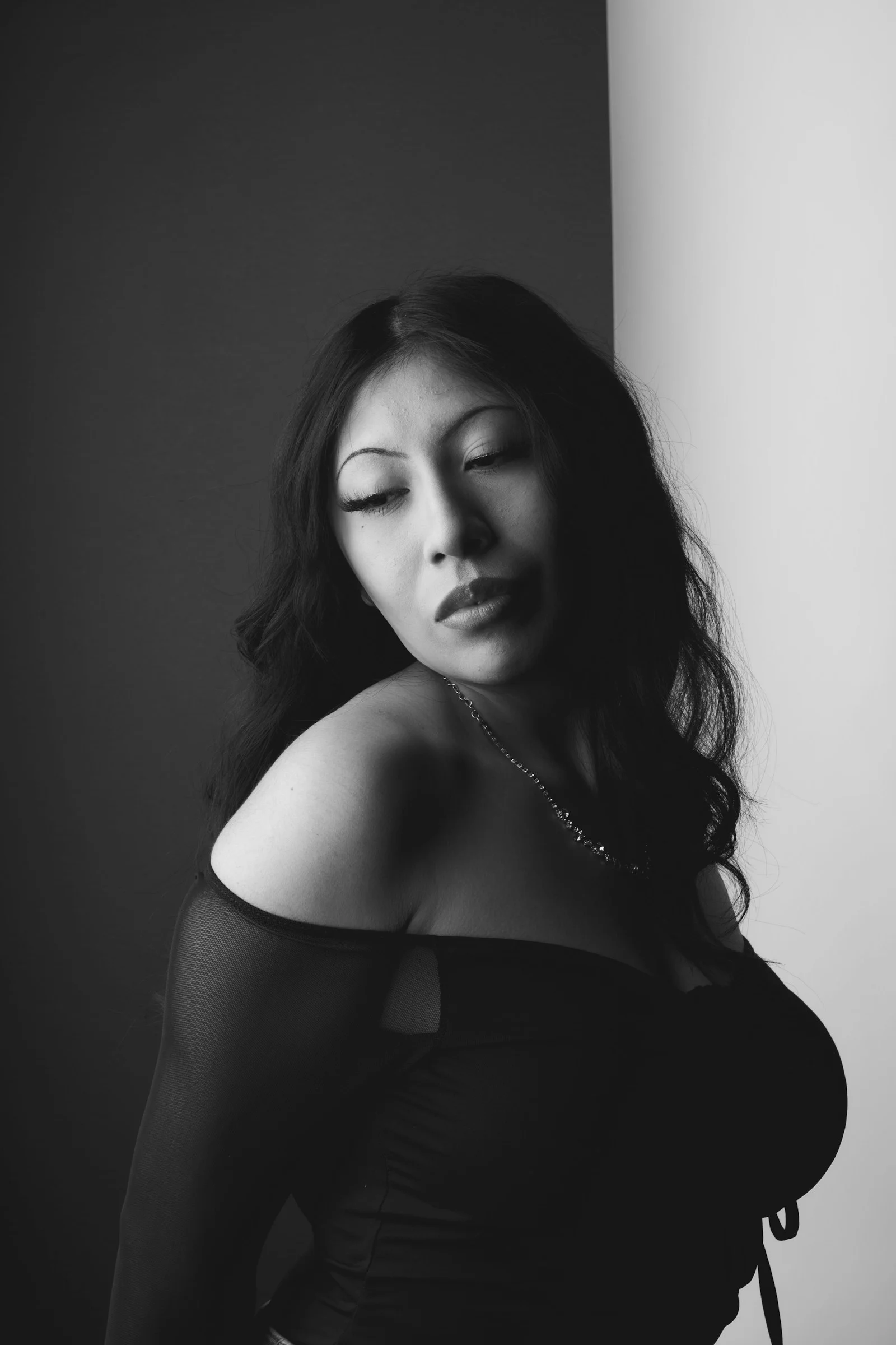 A black and white photo of a woman with her eyes closed