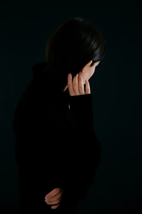a woman with her hand on her face
