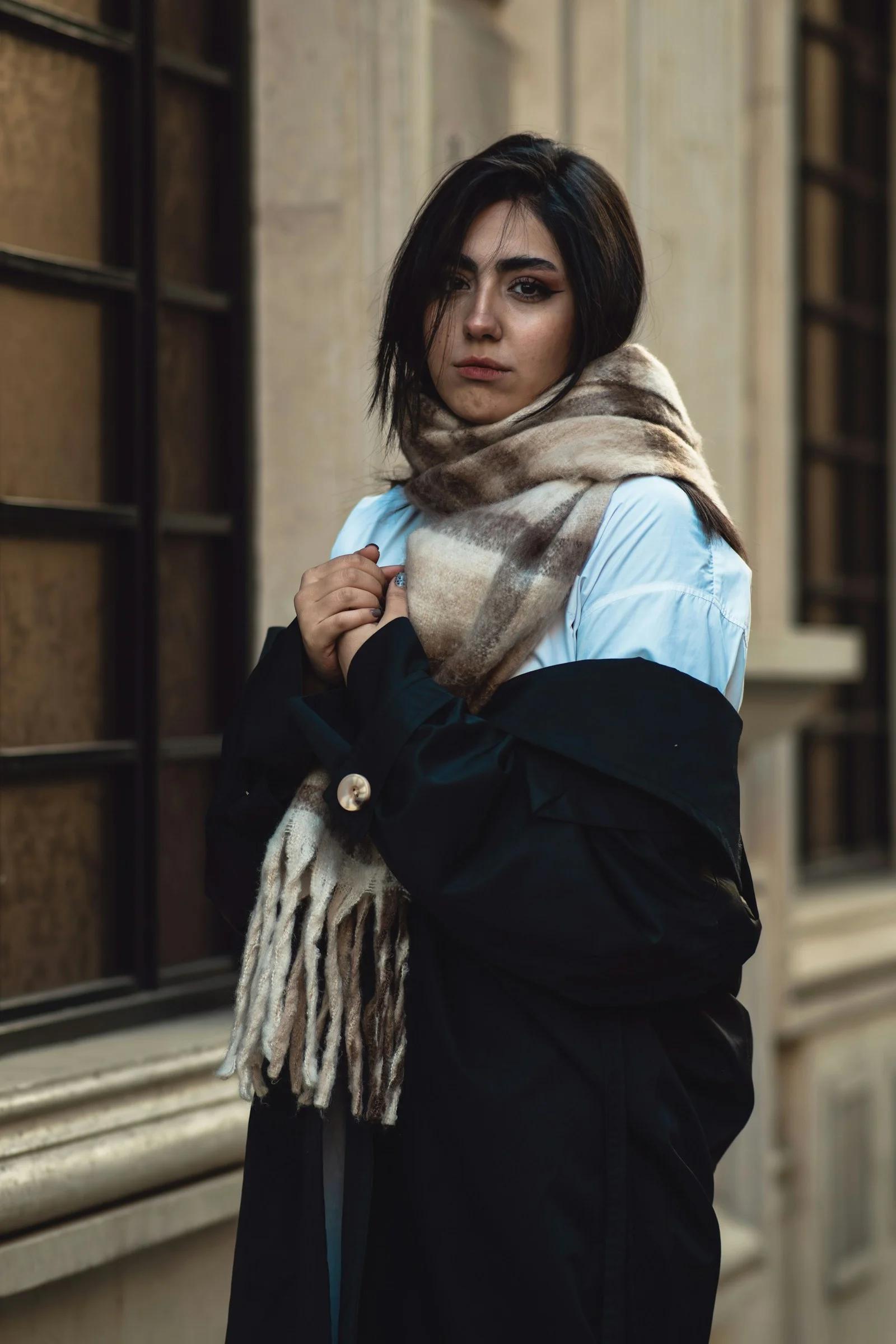 Young woman wearing a scarf and coat outside