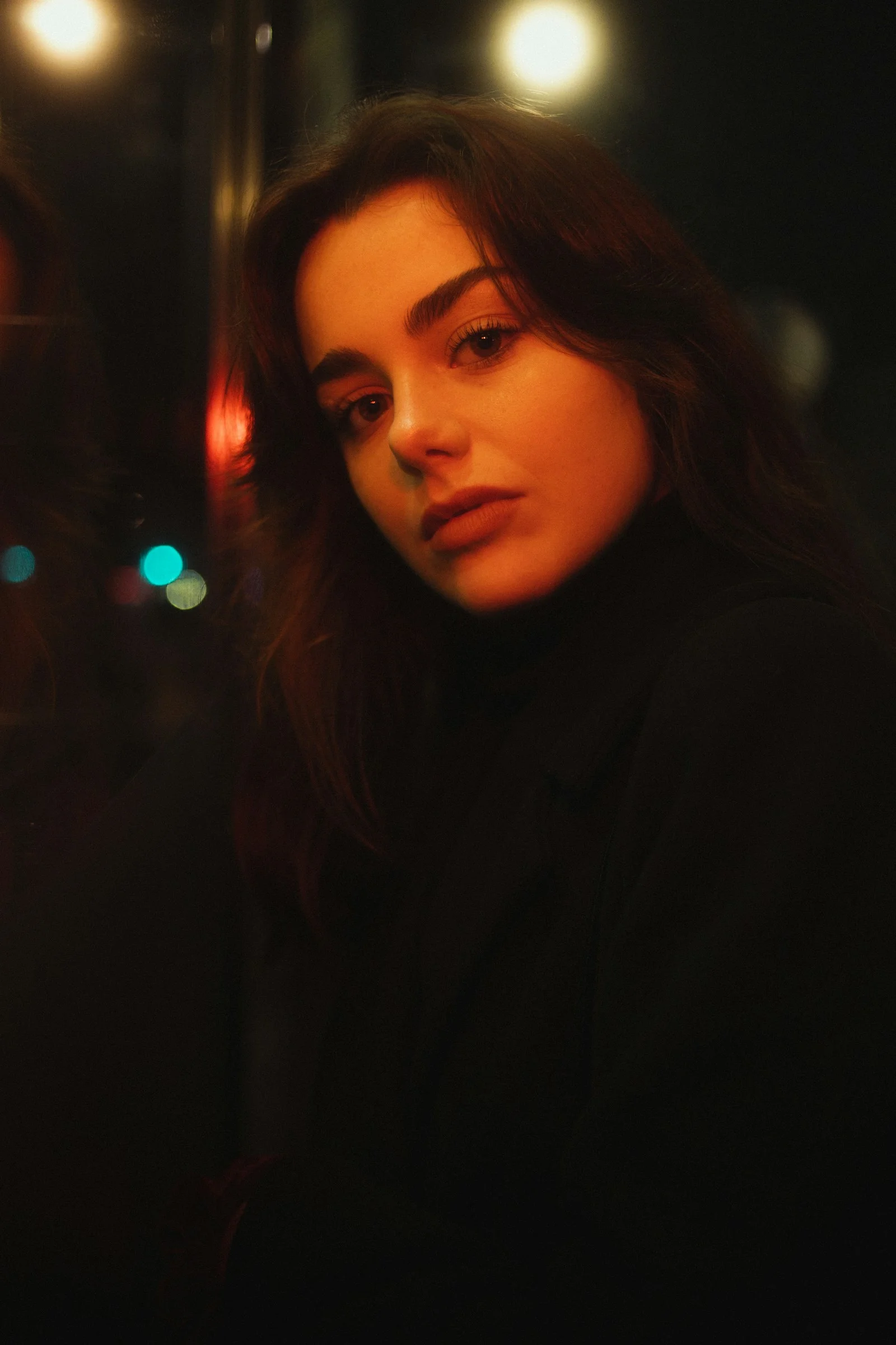 a woman standing in front of a street light