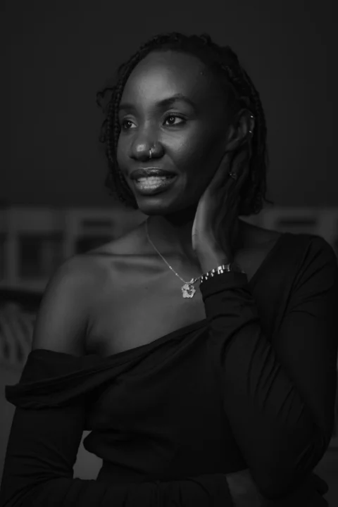 A woman smiles, gazing to the side