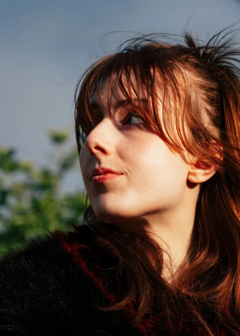 Young woman with red hair looking to the side