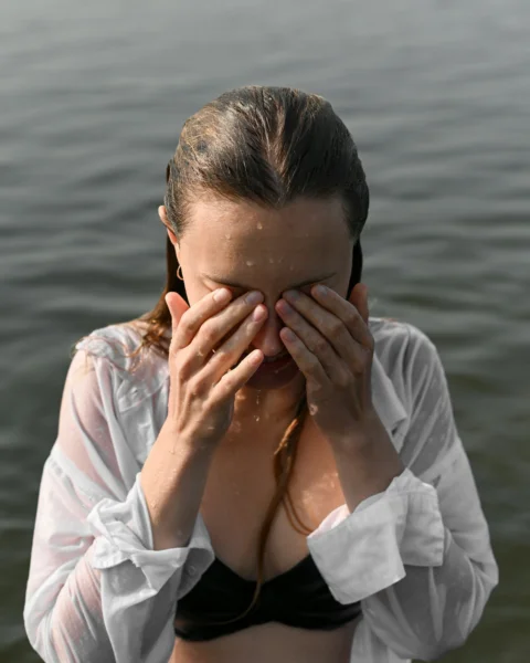 a person covering the face with the hands