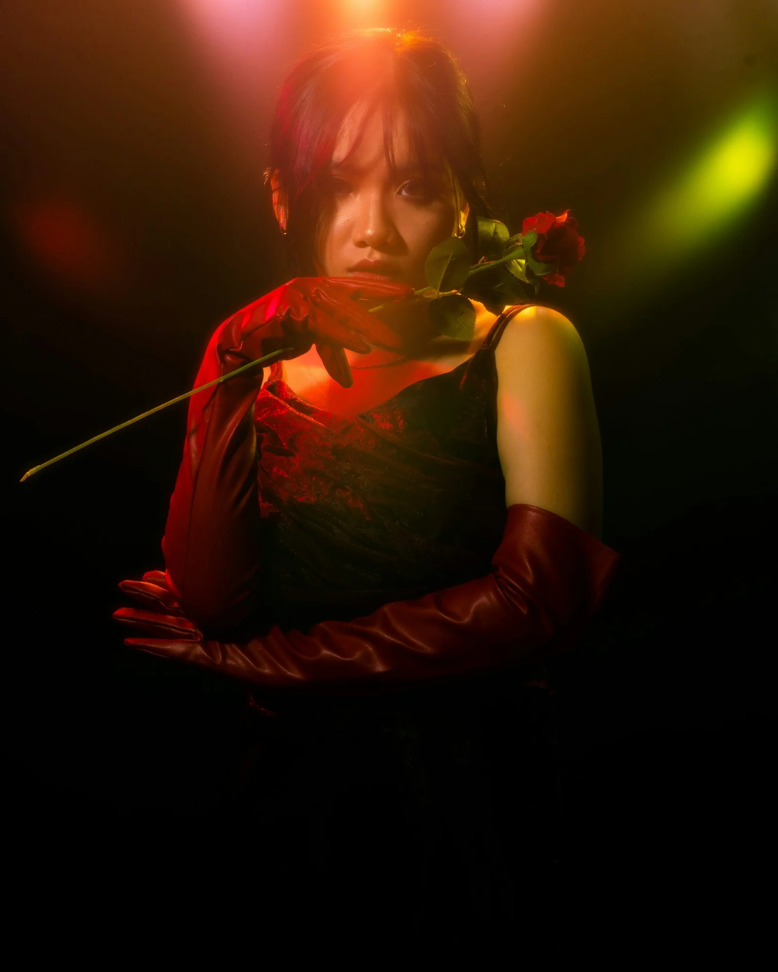 a woman in a red dress holding a rose