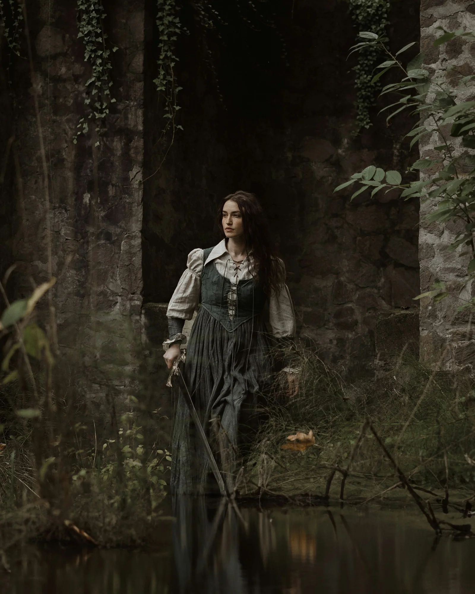 a woman in a dress is standing in the water