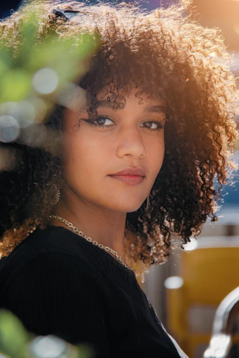 A close up of a person with curly hair