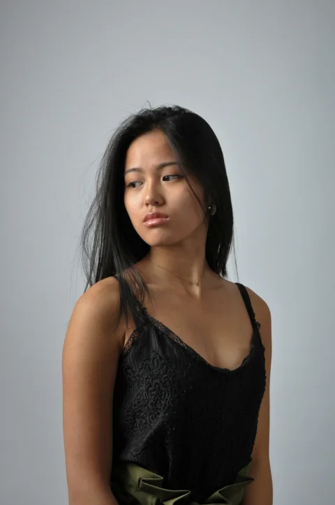 a woman in a black top is posing for a picture