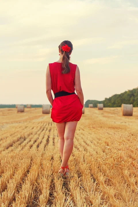 young woman, in red, on the field, cleaning