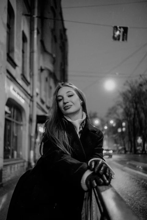 Woman in coat and gloves on city street