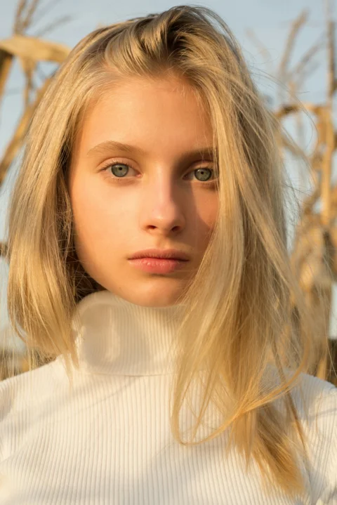 A young woman with blonde hair and blue eyes