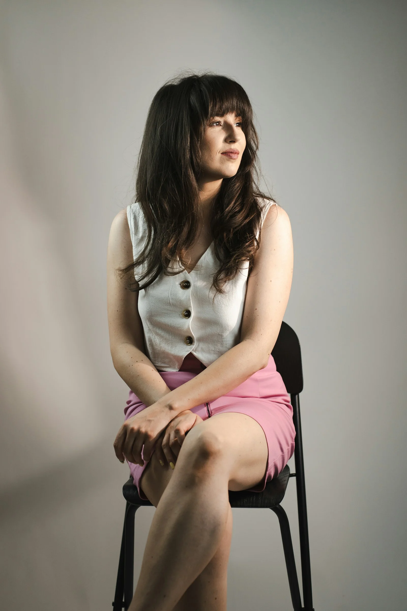 A woman is sitting and looking away