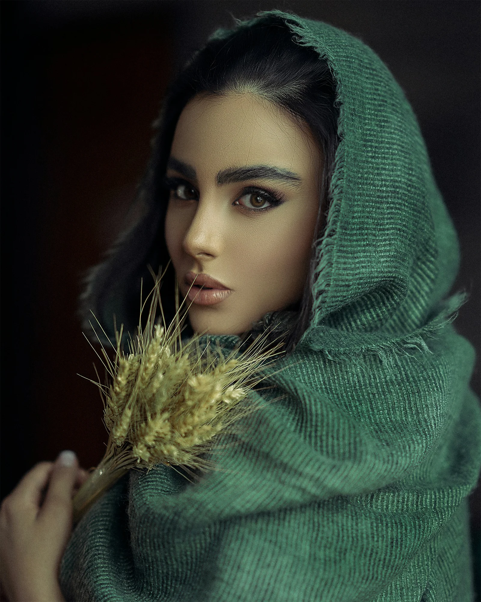 a woman with a green head scarf