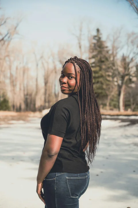 woman in black t-shirt and black pants standing on white sand during daytime