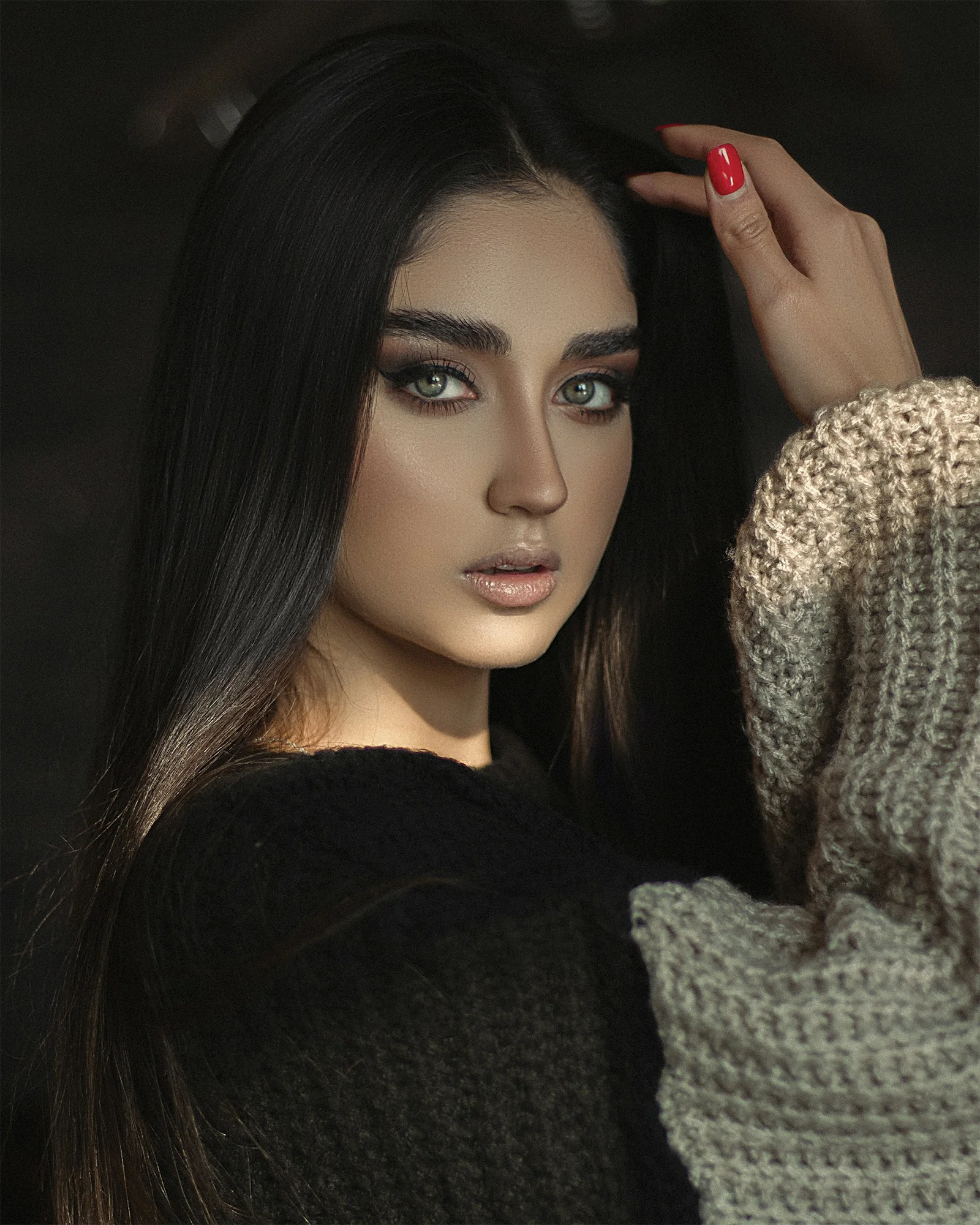 a woman with long black hair and blue eyes