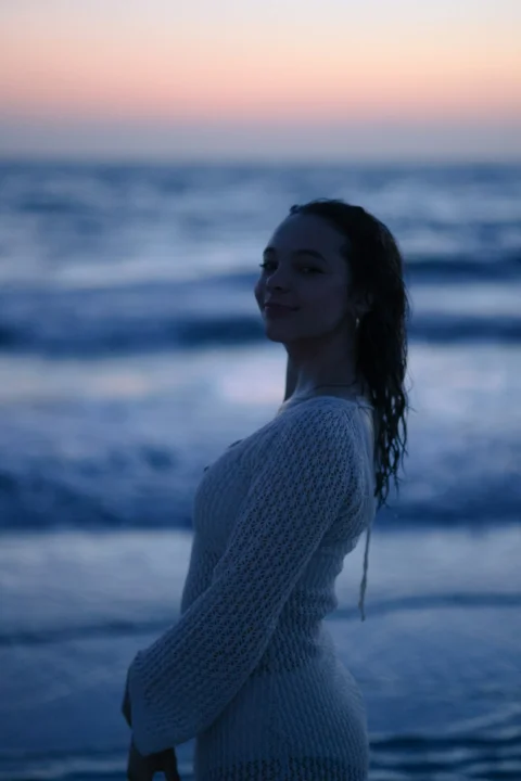 黄昏时分一名女子在海滩上微笑