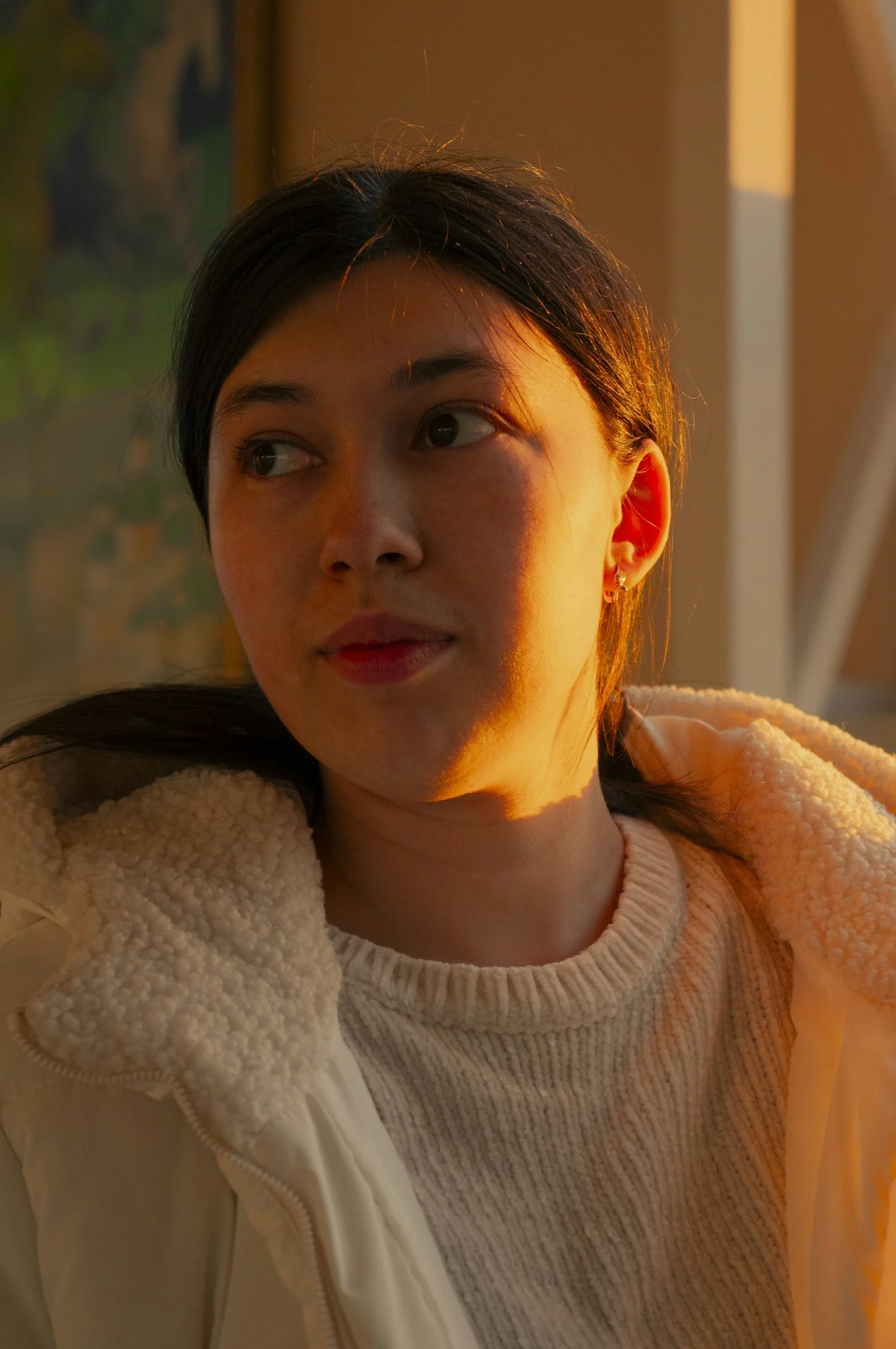 A woman in a white sweater and a white jacket