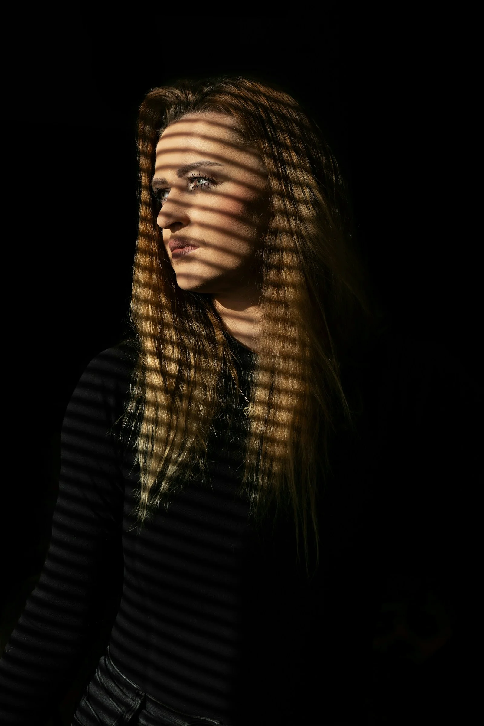A woman standing in front of a black background