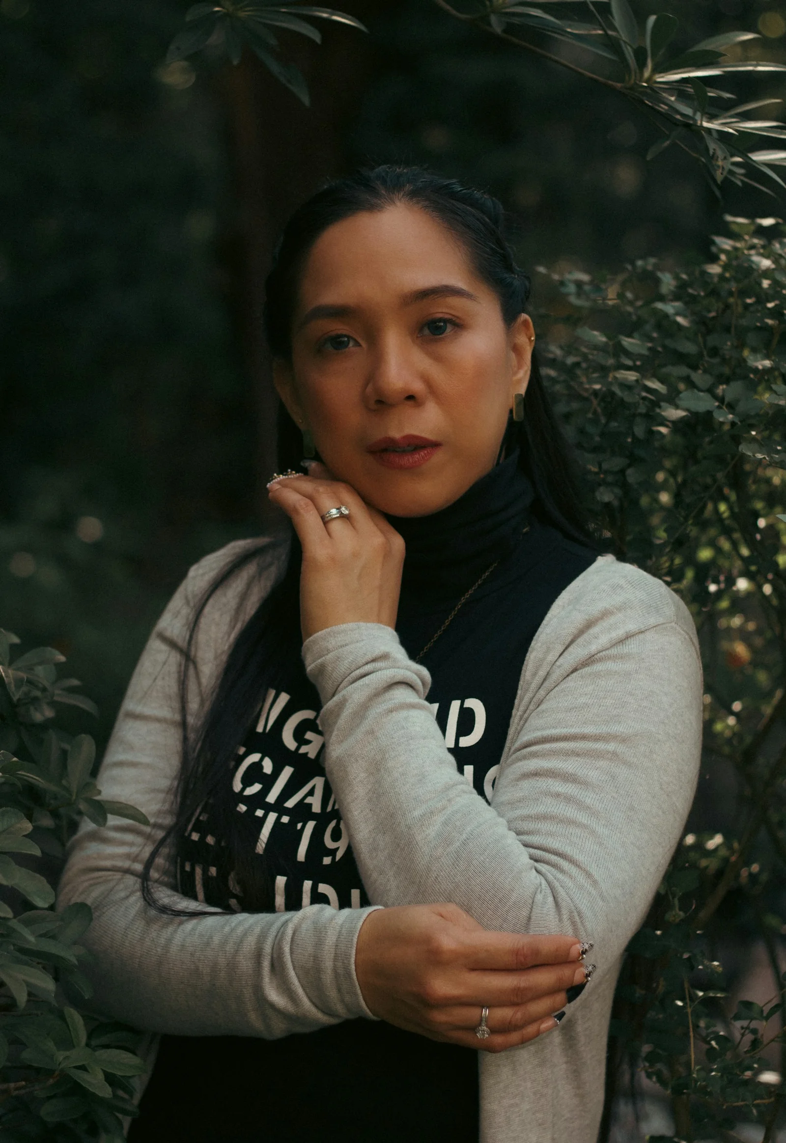 a woman standing in front of a tree