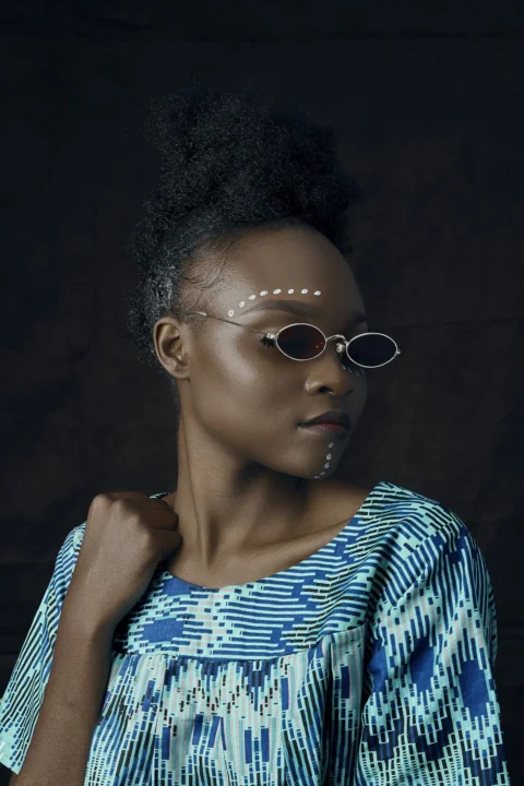 woman in blue and white striped shirt wearing sunglasses