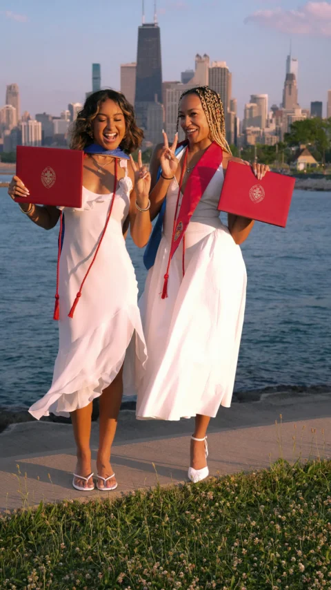 Two beautiful young women standing next to each other