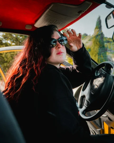 Woman in sunglasses sitting in a car