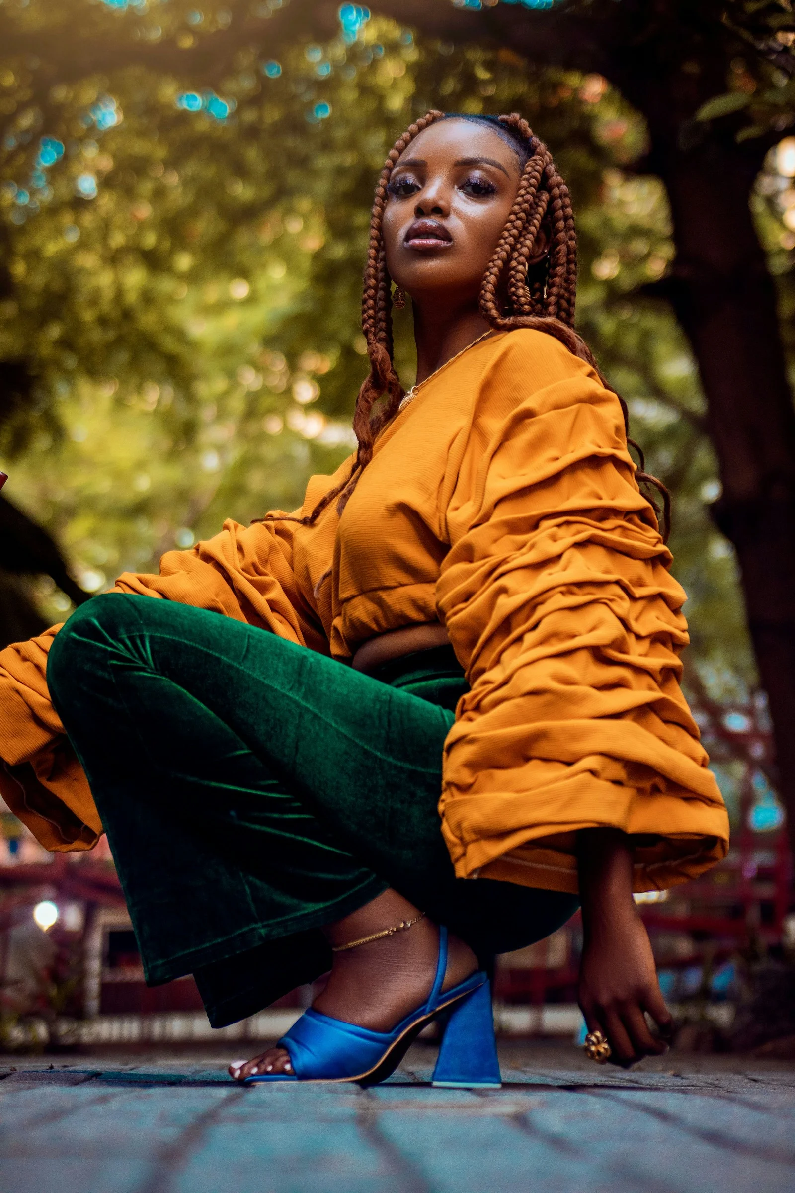 a woman sitting on the ground with her legs crossed
