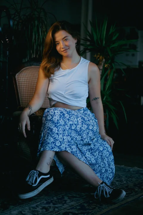 a woman sitting on a chair in a room