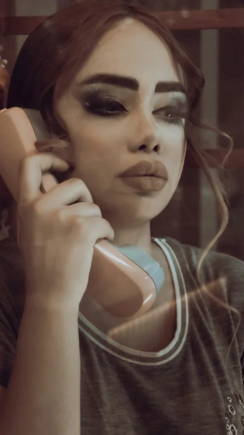 a woman holding a cell phone to her ear