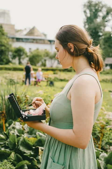 a woman in a green dress holding a laptop