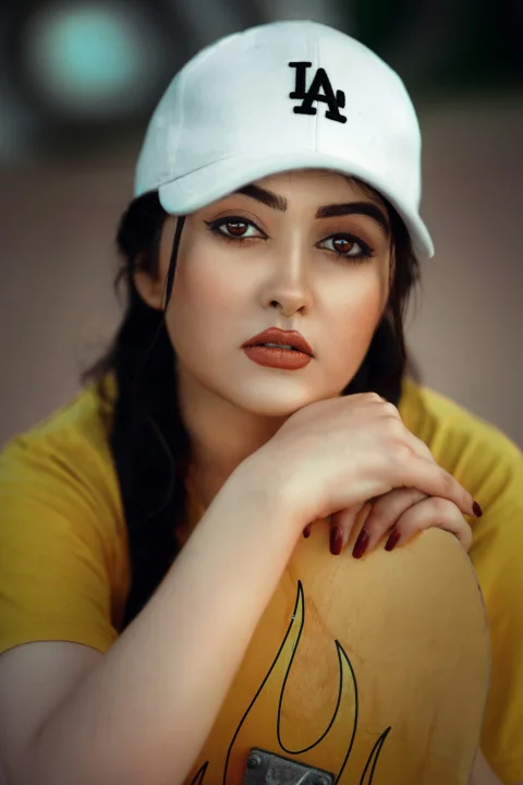 a woman in a yellow shirt and a white hat