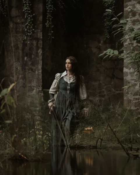 a woman in a dress is standing in the water