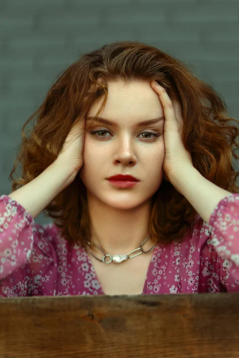 a woman with her hand on her head