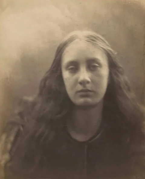 A vintage portrait of a woman with long, dark hair