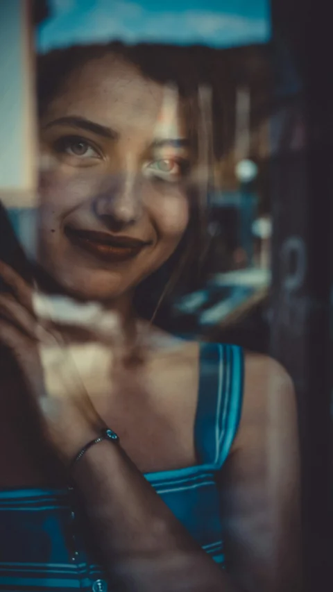 woman in blue tank top smiling