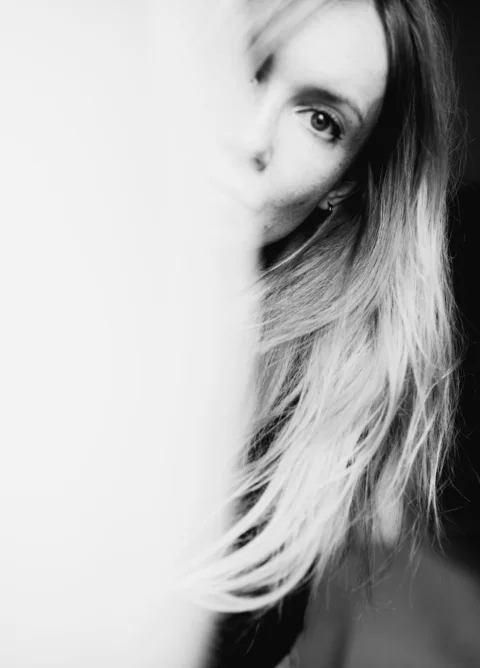 A black and white photo of a woman with long hair