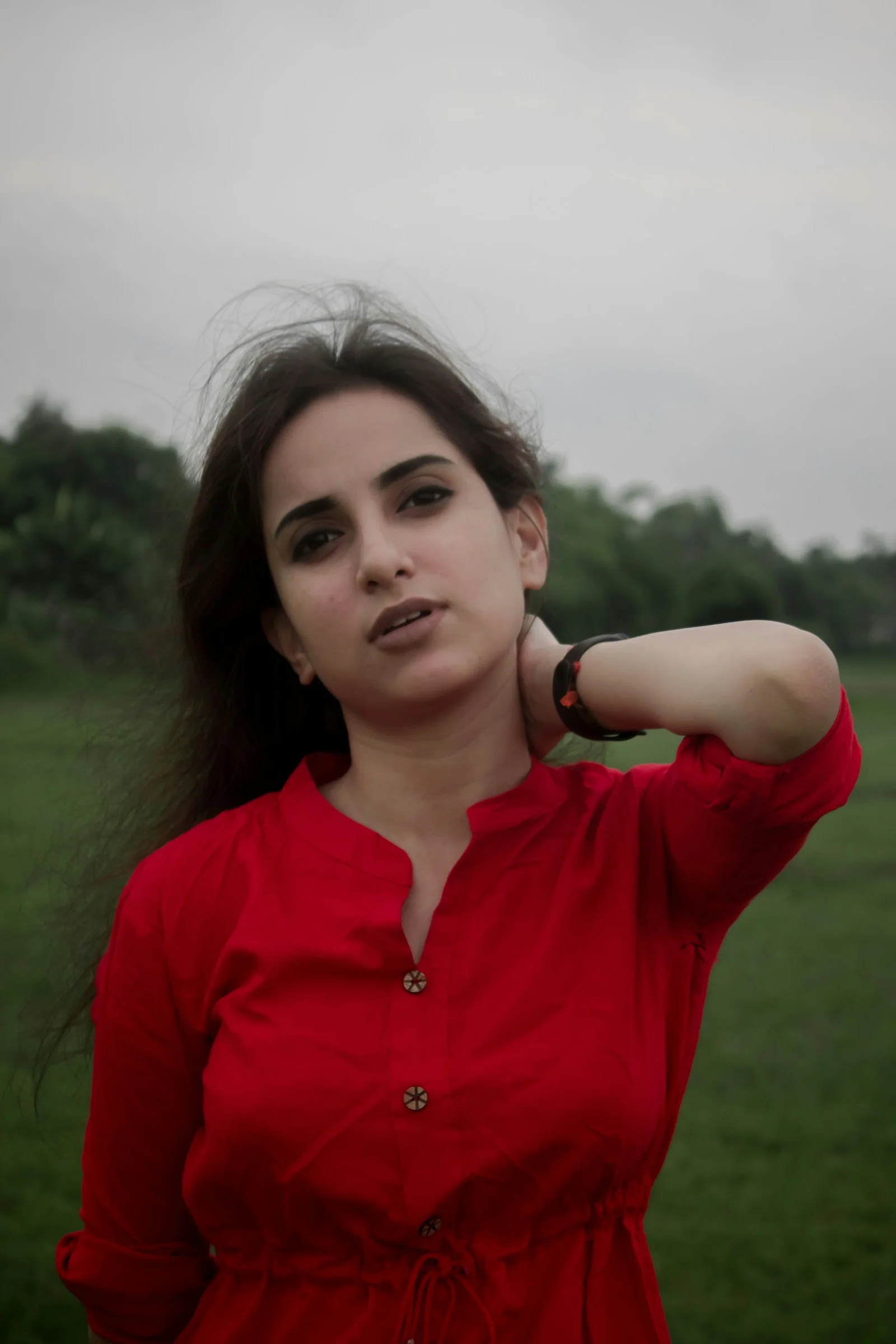 woman in red button up shirt smiling