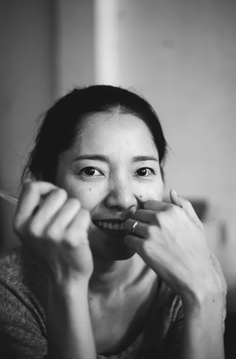 grayscale photo of woman holding her face