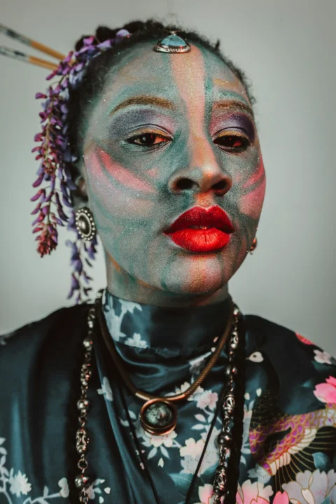 Woman with artistic face paint and elaborate jewelry
