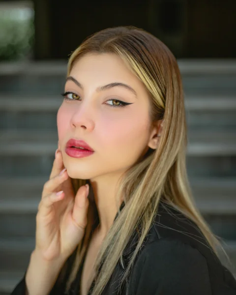 a woman with long blonde hair is posing for a picture