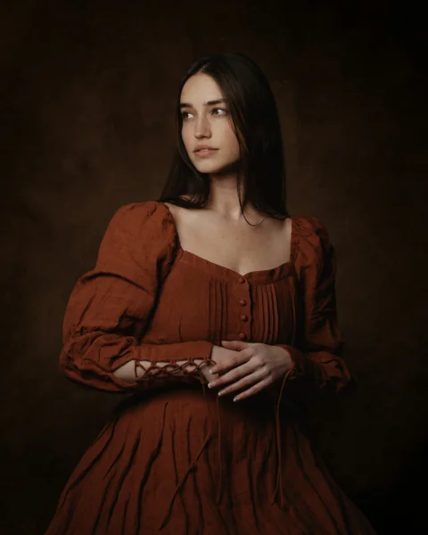 a woman in a red dress posing for a picture