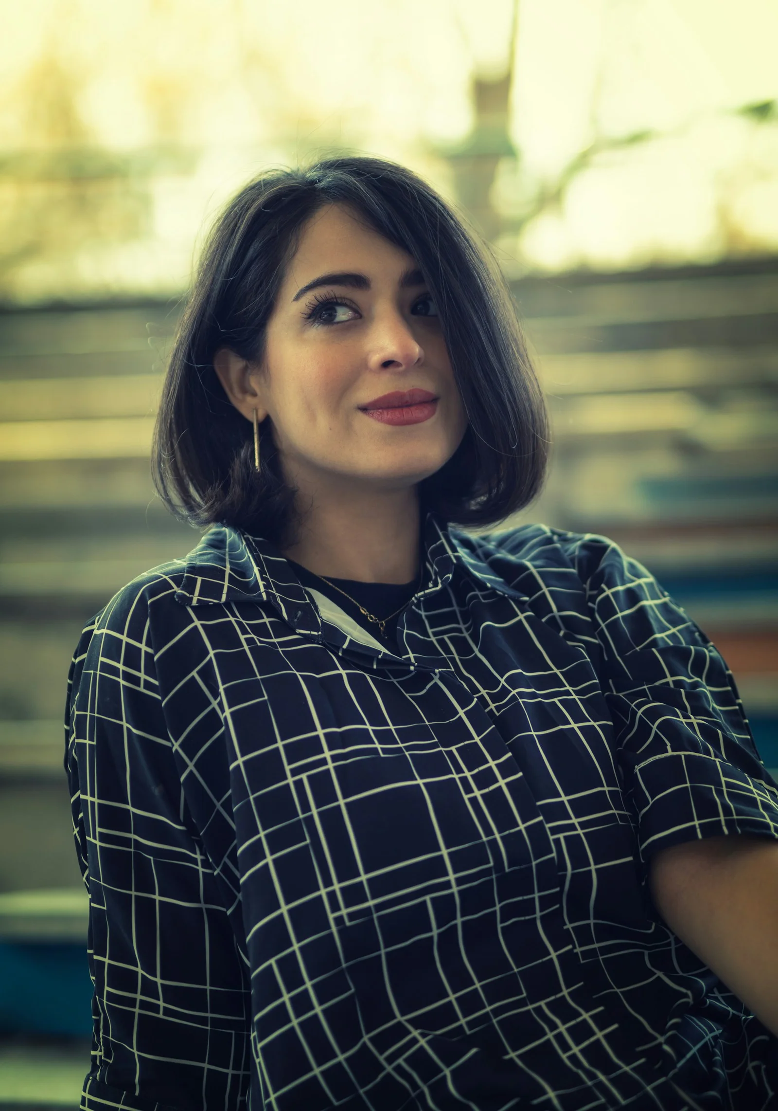 a woman with short hair wearing a black and white shirt