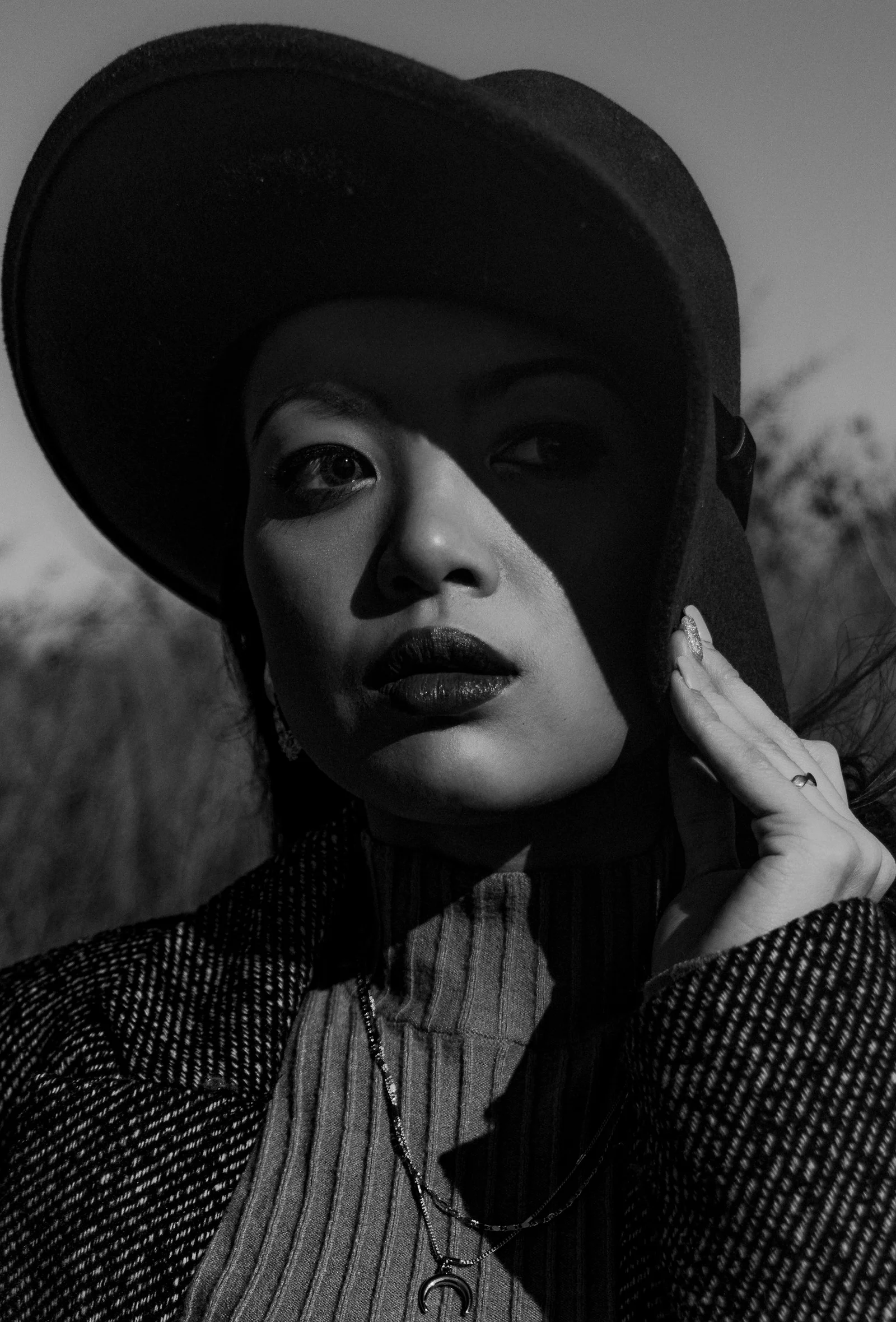 Stylish woman in a hat with dramatic shadows