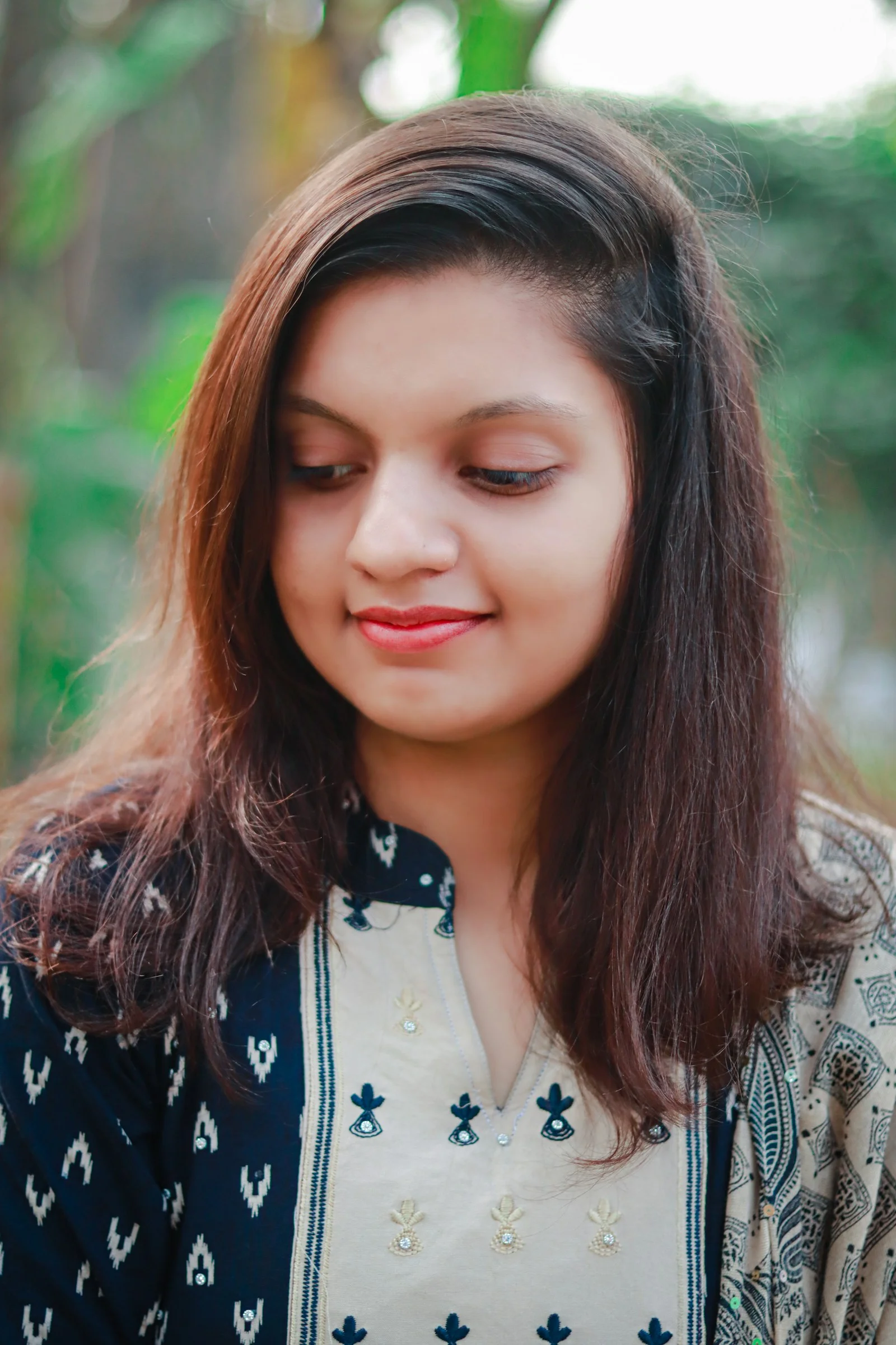 Young woman with long brown hair outdoors