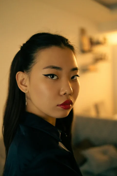 a woman with a black shirt and red lipstick