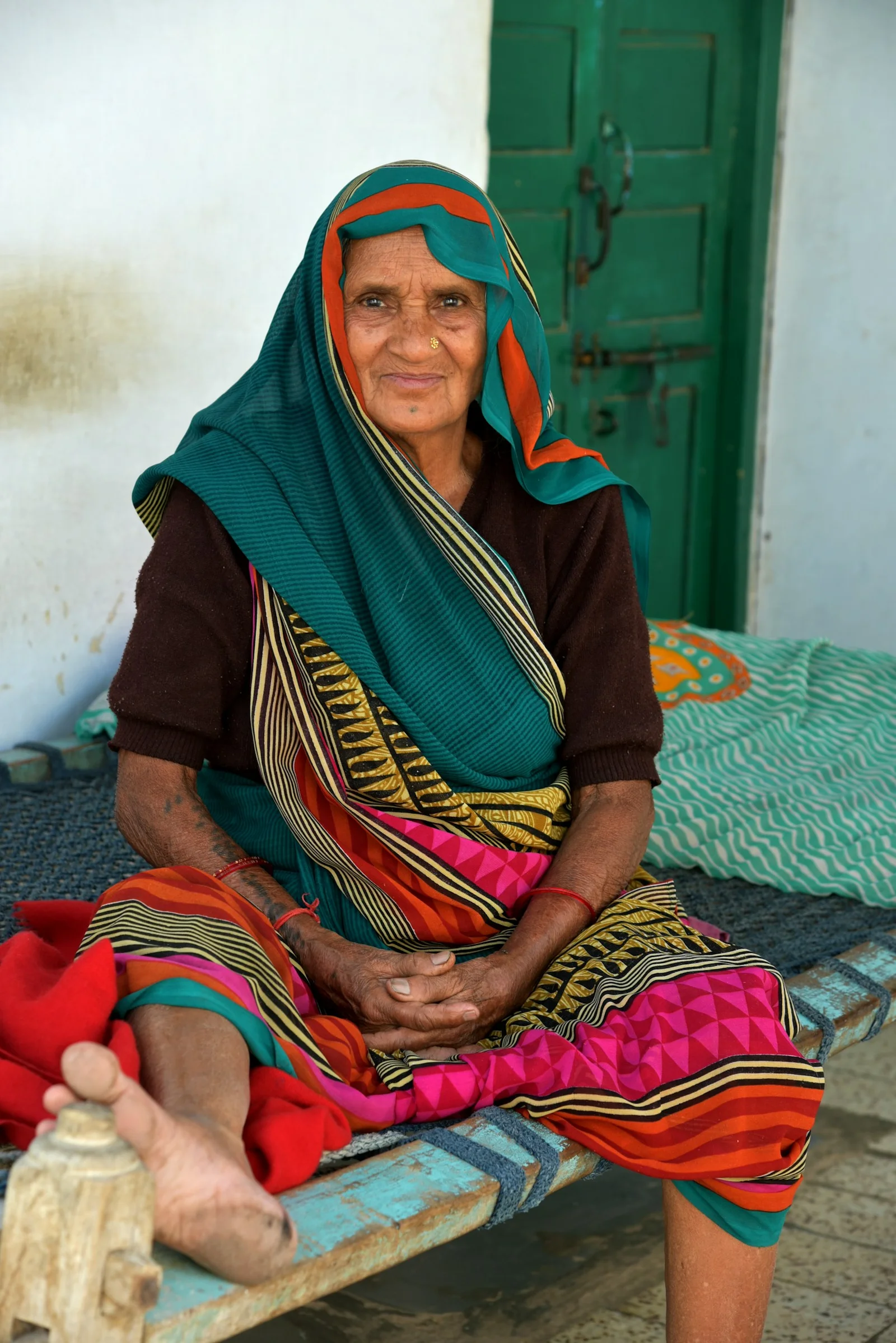 woman in brown and white hijab sitting on bed