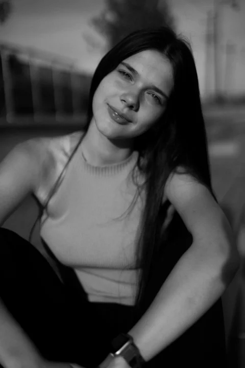 A young woman smiles at the camera