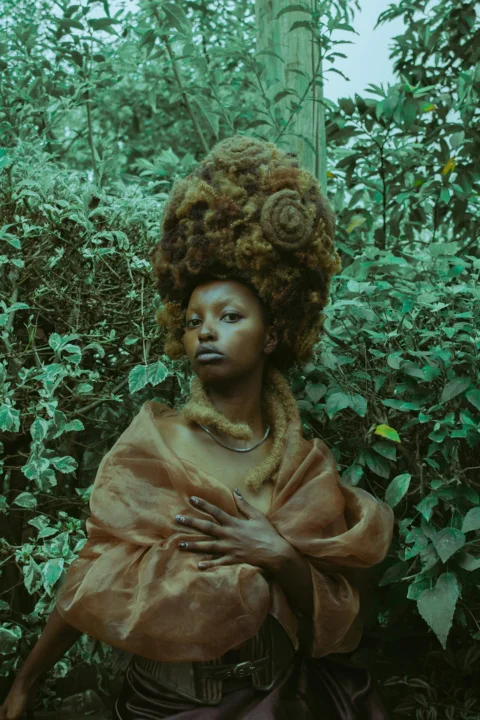 Woman with elaborate hairstyle in lush green foliage