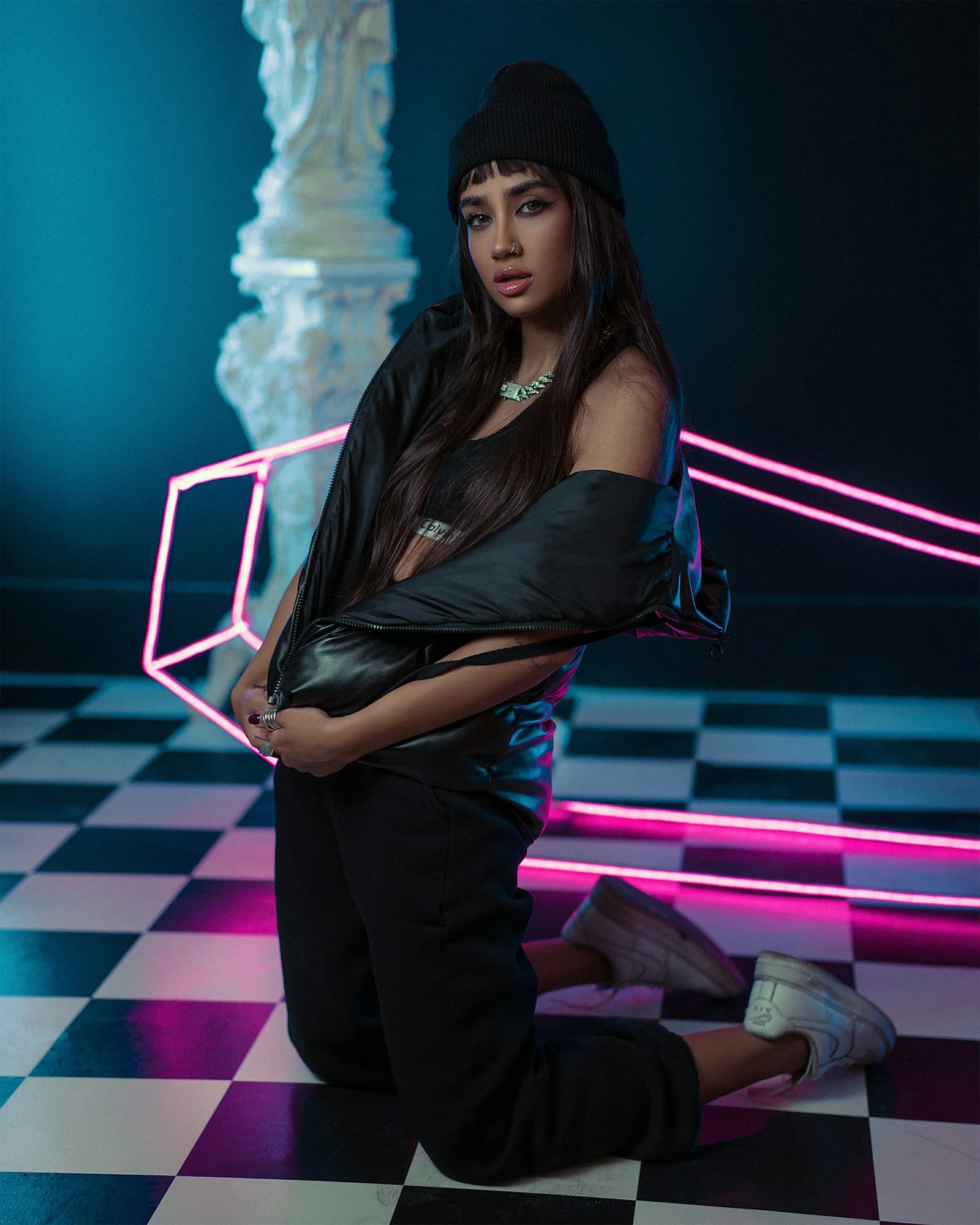 a woman in a black top and black pants posing for a picture